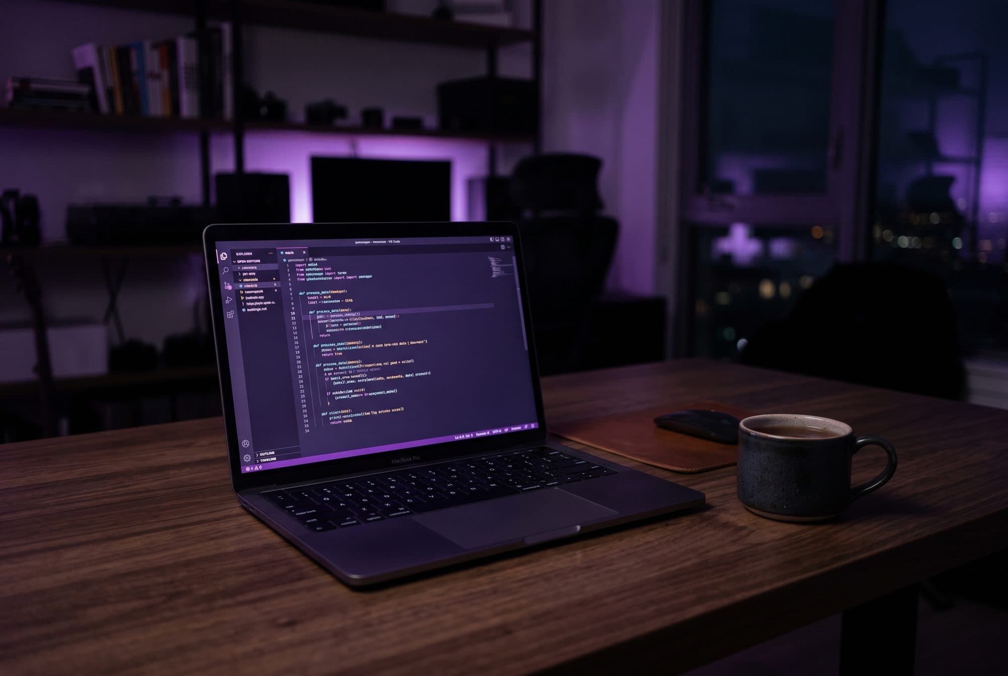 PROCODE workspace in Doha with a laptop showing code